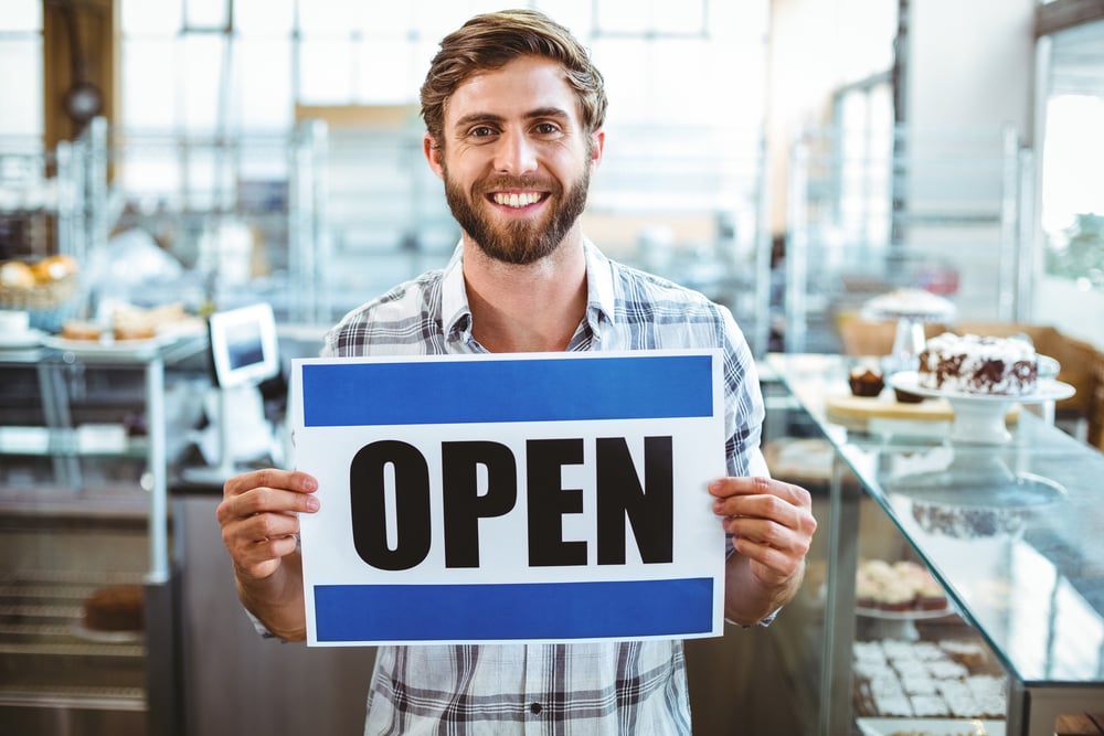 man holding an open sign virtual event open for business