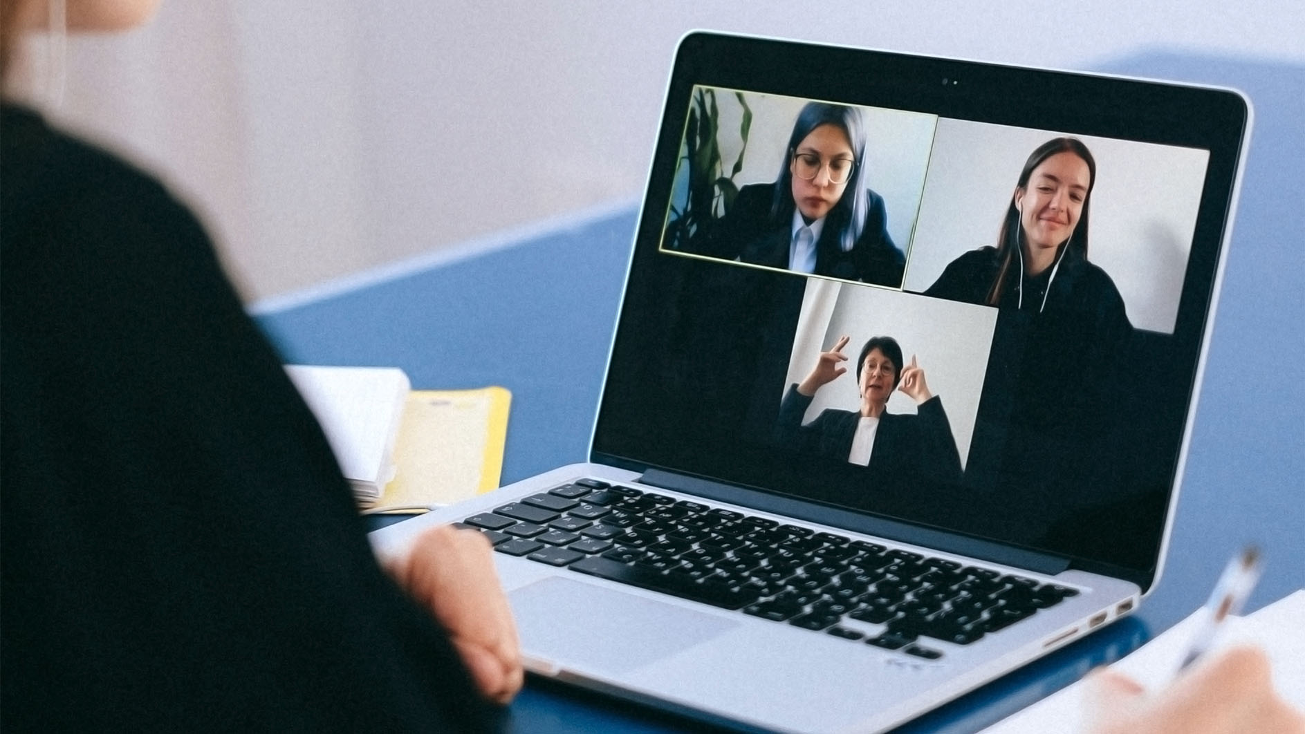 person on webcasting video conferencing call with coworkers